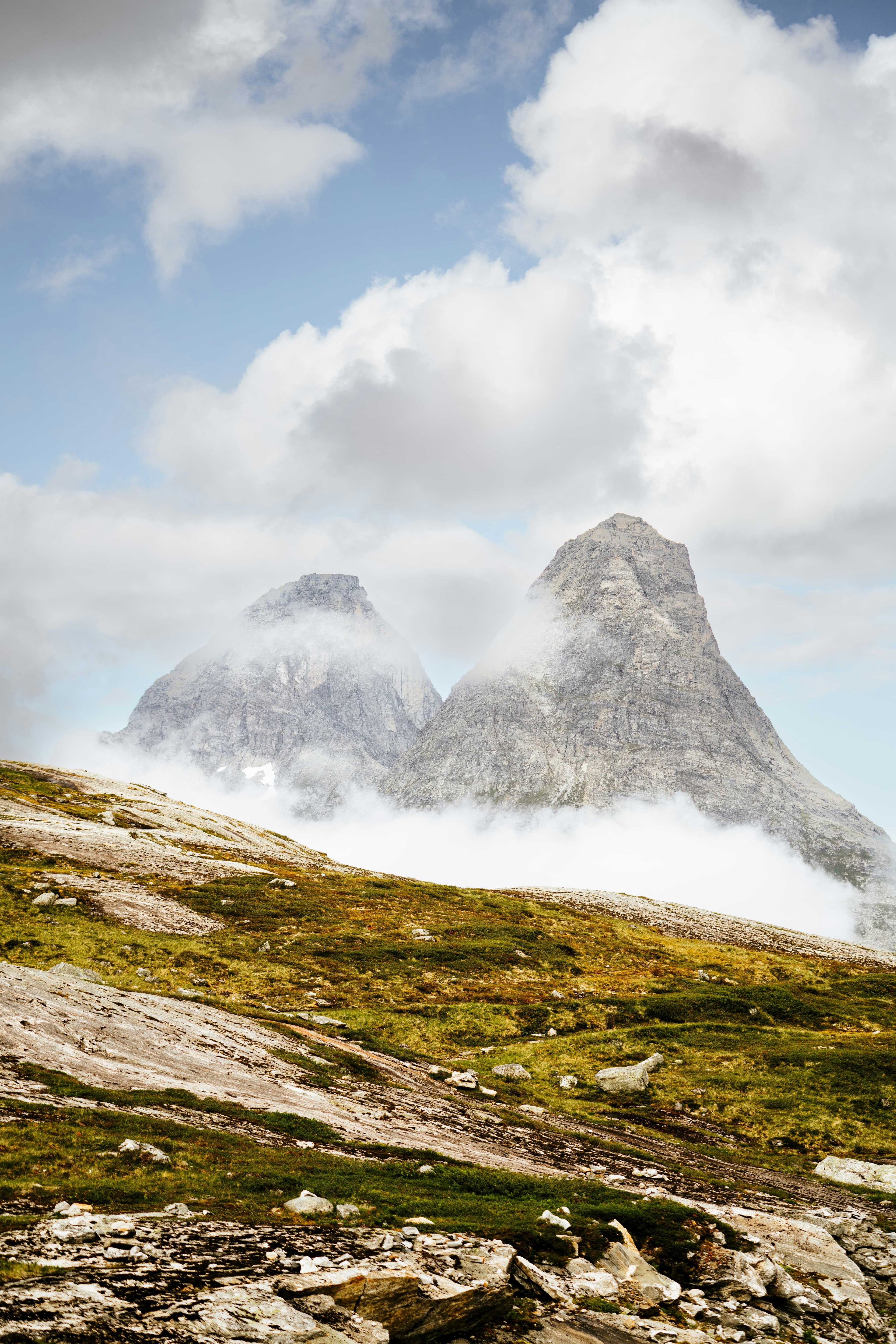 Norwegian mountain peaks emerging through clouds